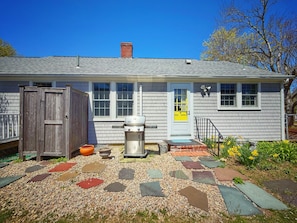 Rear patio are with outdoor shower and bbq grill