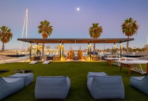Outdoor lounge area with hammocks. Lawn games. Marina view. Relaxing atmosphere.