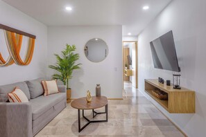 Relax in our stylish living area; Smart TV & comfy seating included.