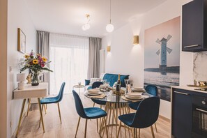 Boutique-style dining area – comfy chairs, round table and luxury finishes just moments from the beach.