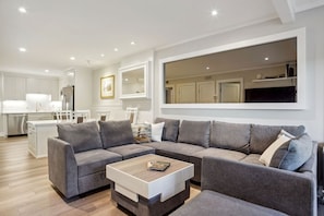 This spacious living room offers a harmonious blend of functionality and aesthetic appeal.