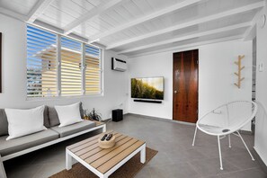 Kick back in the sun-filled lounge, featuring a soft sofa and large window – a perfect space to unwind, read a book, or binge your favorite series in comfort.