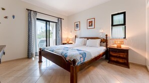 Warm and inviting master bedroom with classic wooden furnishings and access to a private outdoor space
#MasterBedroom #BalconyAccess #RusticCharm #PeacefulStay #PortugalRetreat #LovelyStay