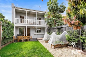 Backyard with garden, BBQ and outdoor table for 6 people