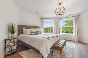 The chic primary king suite boasts a smart TV, ensuite, & balcony access