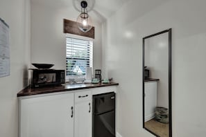 A microwave, coffee pot, and mini fridge are provided for your convenience