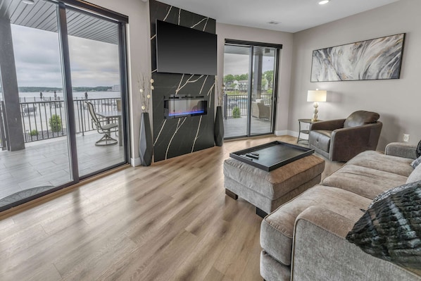 Bright living area with electric fireplace, Smart TV, and ample seating