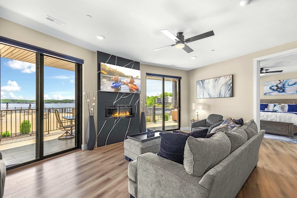 Bright living area with electric fireplace, Smart TV, and ample seating