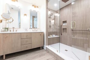 The spa-like ensuite bathroom is designed for comfort and convenience, boasting a walk-in shower, double vanity, and luxurious toiletries