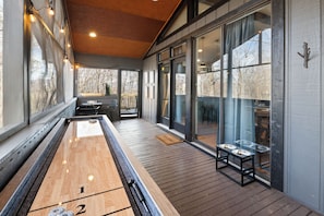 Step from the screened-in porch into the heart of the home, the living and dining area.