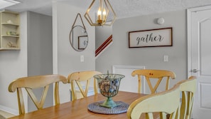 The serene dining table offers comfortable seating for 6