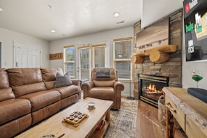 Experience the cozy living room with fireplace.