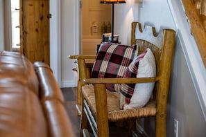 The entry has seating for two in the living room.