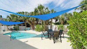 One of the Al Fresco dining tables with a shade sail