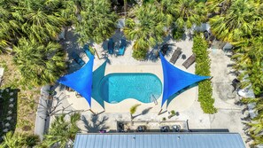 Aerial view of pool and patio.  Shade sails additional comfort.
