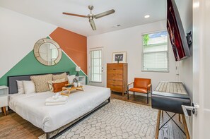Spacious suite with a king bed, Smart TV, walk-in closet, private balcony, and en-suite bath.