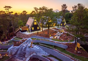 A breathtaking aerial view of your mini golf village getaway at golden hour.