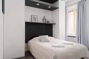 Rest easy in a plush queen-sized bed with premium linens and blackout curtains for deep sleep.