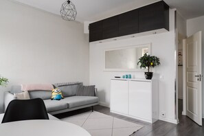 Bright, stylish living room with cozy seating, perfect for relaxing after exploring Helsinki.