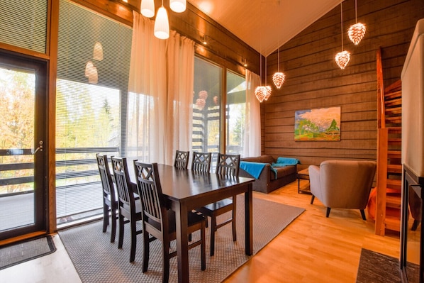 Warm and inviting living room/dining room with a fireplace & sofabed — perfect for relaxing after a day of exploring.