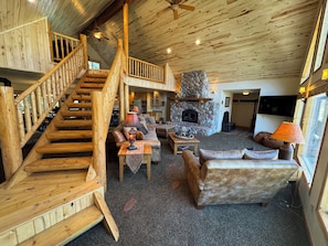Complete with lots of comfy lounging, a huge stone fireplace and a 65 inch tv.