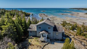 Escape to a secluded lakefront home with panoramic views and direct access to pristine Georgian Bay shoreline.