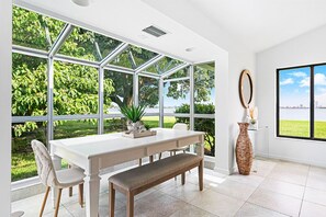 Indoor dining area bathed in natural light, with views of the outdoors, creating a serene space for enjoying meals together.