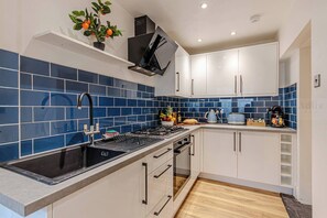 Bright kitchen with a retro fridge and stylish details, smoothly connecting to the dining area