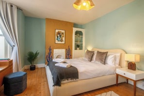 Master Bedroom:
Serene king bedroom with calming blue walls, vintage wardrobe, and soft lighting, offering a peaceful retreat to unwind.