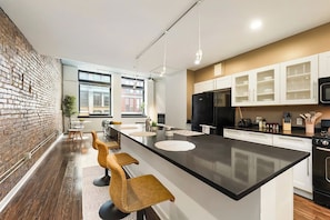 A fully equipped modern kitchen with top-notch appliances and all essentials for cooking or dining in.