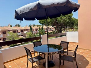 back terrace with BBQ and views of the garden and pool