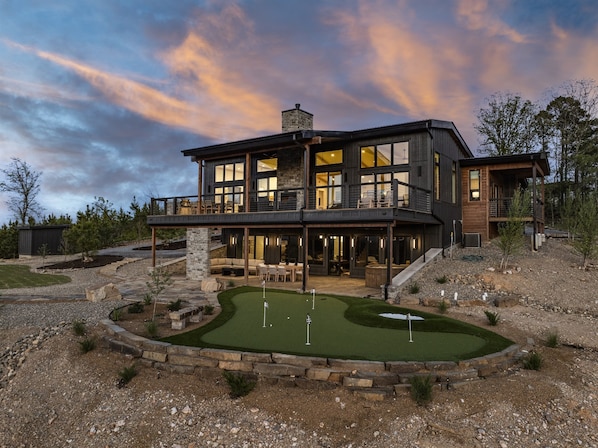 Backyard views at Harmony Hill showcase the elite putting green, a spacious outdoor deck, and the custom-designed Sorrel Barrel-style hot tub—perfect for relaxing and enjoying the scenic surroundings.