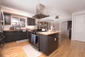 Modern kitchen abundantly equipped for cooking and serving 8 guests.
