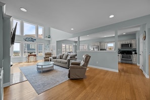 Spacious and airy home with a loft area and a cozy fireplace.