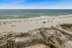 View of beach and pool from balcony.