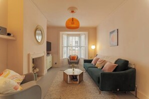 Warm and comfortable living room with Smart TV, streaming speaker, games