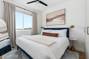 Bedroom 2: Relax in luxury on a memory foam mattress within this welcoming bedroom featuring a smart TV.