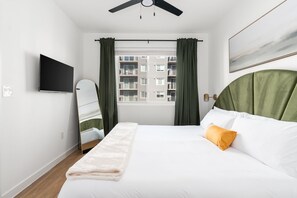 Experience a tranquil rest on a memory foam mattress in this cozy bedroom equipped with a 40' smart TV.