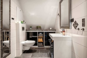 Spacious bathroom with stylish finishes and storage.