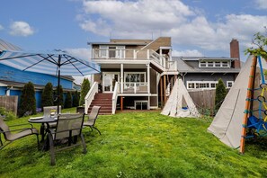 Outdoor bliss awaits with lounge seating, a Traeger grill, and a rock wall for adventure seekers in our spacious backyard!