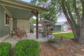 The beautifully landscaped backyard provides a tranquil retreat for unwinding after a day exploring the town.