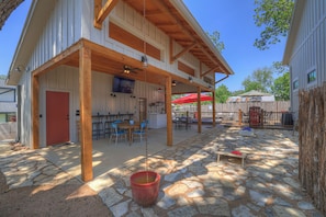 Outdoor space with a covered patio, games, TV and swim spa