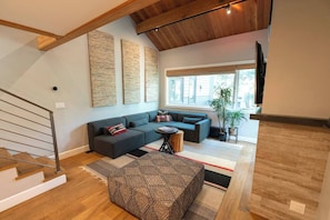 Living room with TV and electric fireplace.