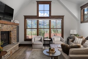 Living room features large windows with unobstructed mountain views