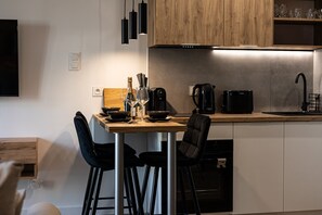 Elegant evening setup with wine glasses and balcony access, overlooking central Bydgoszcz, just minutes from Opera Nova and Mill Island.