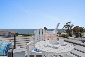 Chilled coastal vibes on the rooftop terrace with ocean views and refreshing drinks.