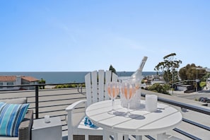 Chilled coastal vibes on the rooftop terrace with ocean views and refreshing drinks.