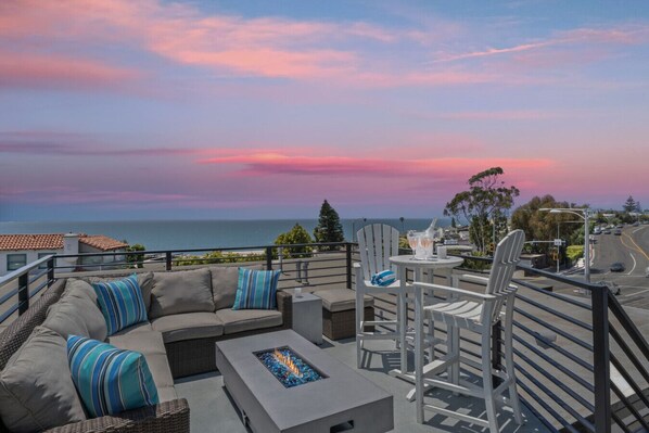 Stunning sunset view from the dining area, overlooking the coastline.