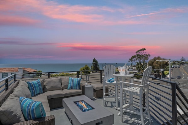 Stunning sunset view from the dining area, overlooking the coastline.