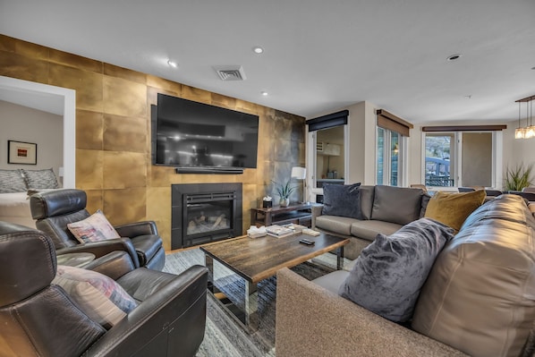 Living room: 75" Smart TV, gas fireplace, Sonos sound system, pool table, patio access, central heating and A/C